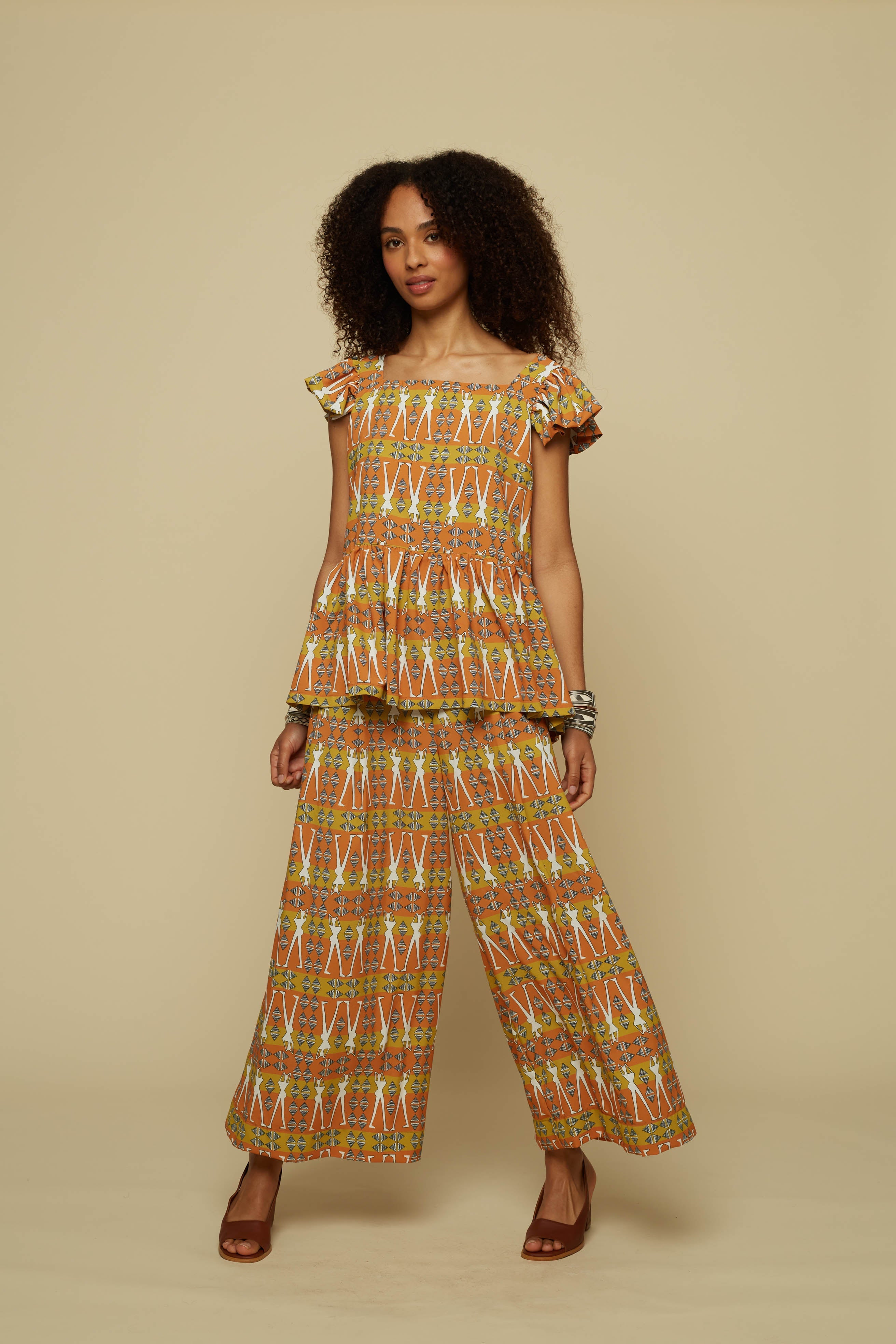 SCHEMA PANTS (BROWN GEO HUMAN FIGURE PRINT)