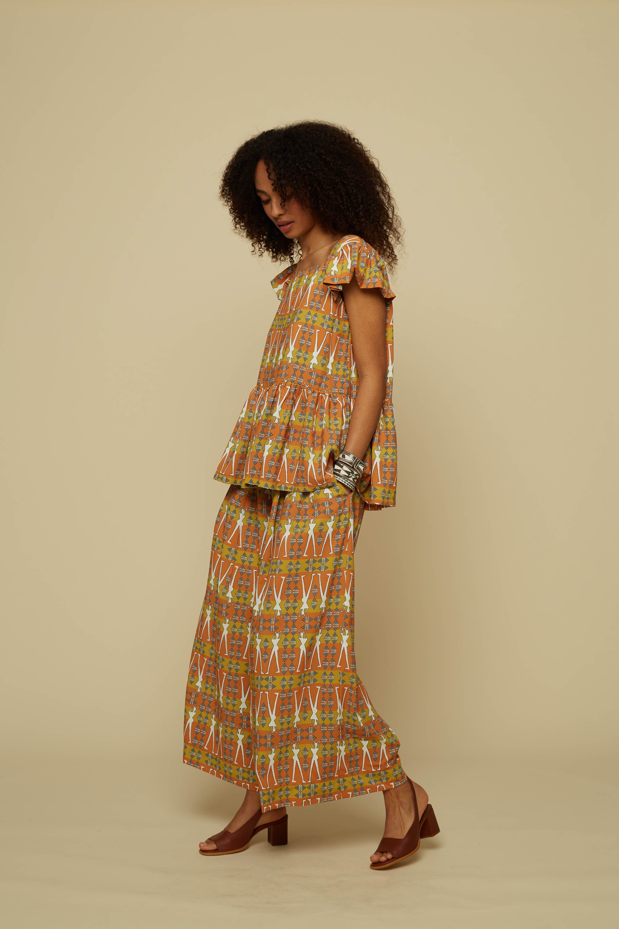 SCHEMA PANTS (BROWN GEO HUMAN FIGURE PRINT)