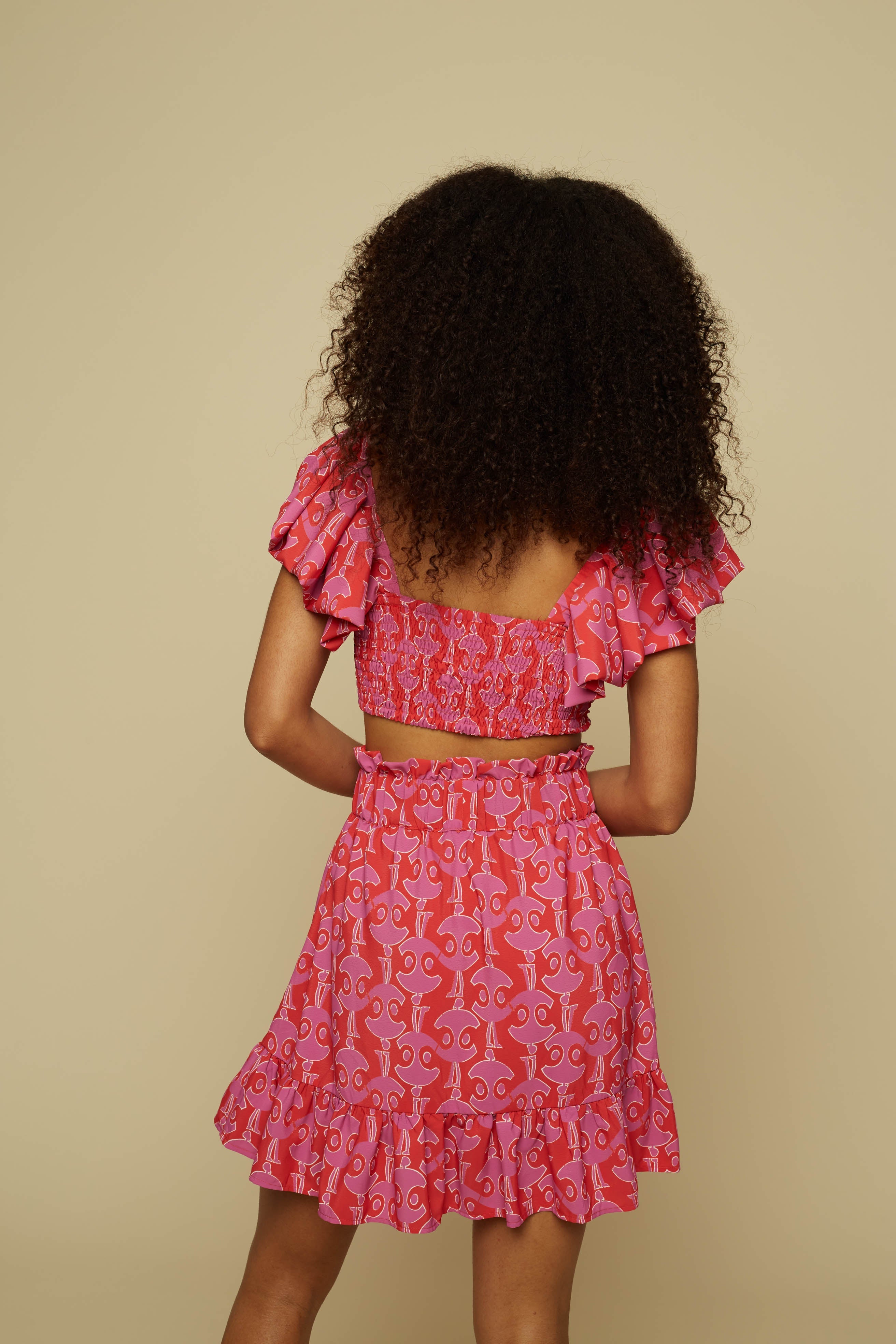 TECTON MINI SKIRT (PINK GEO PEOPLE PRINT)