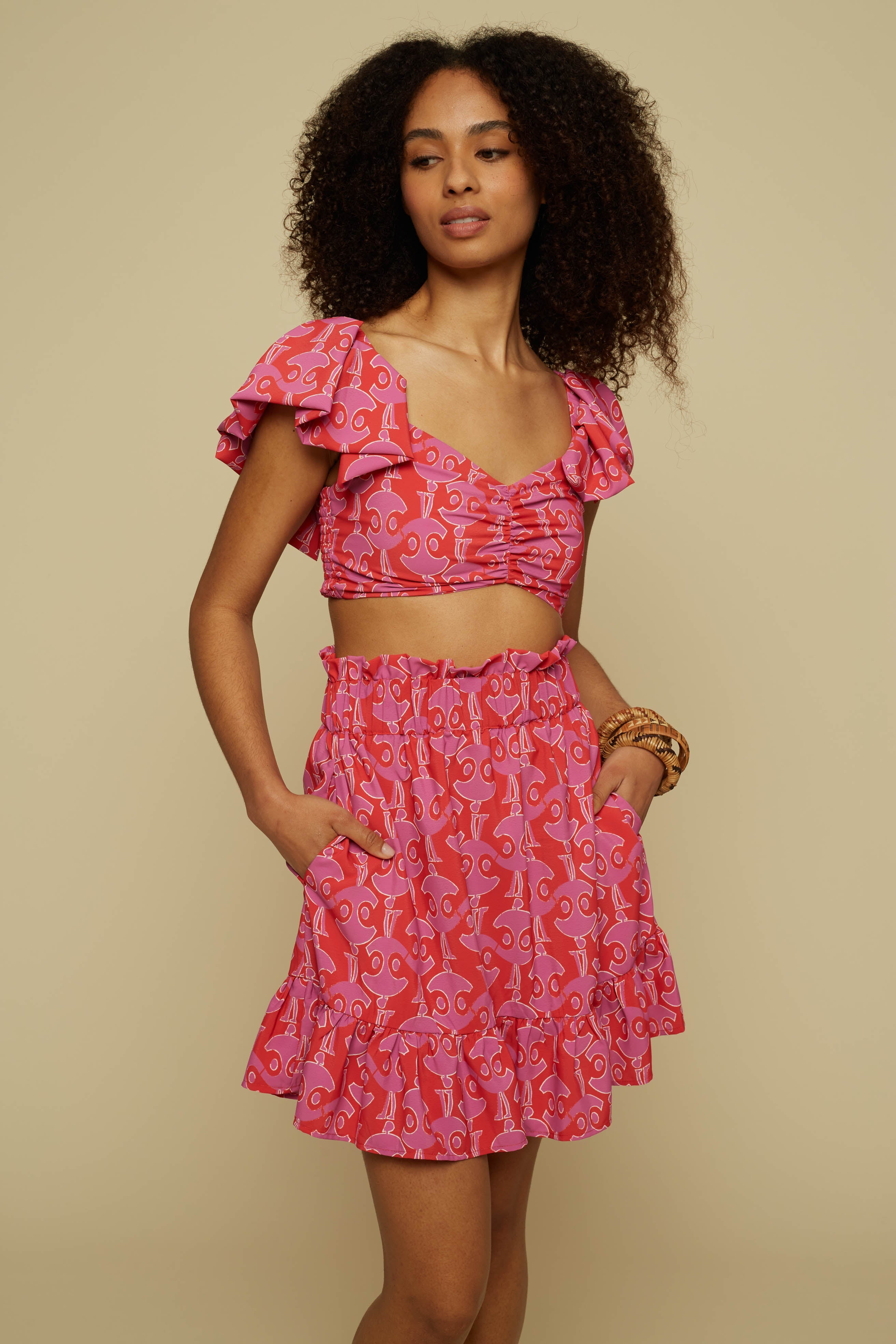TECTON MINI SKIRT (PINK GEO PEOPLE PRINT)