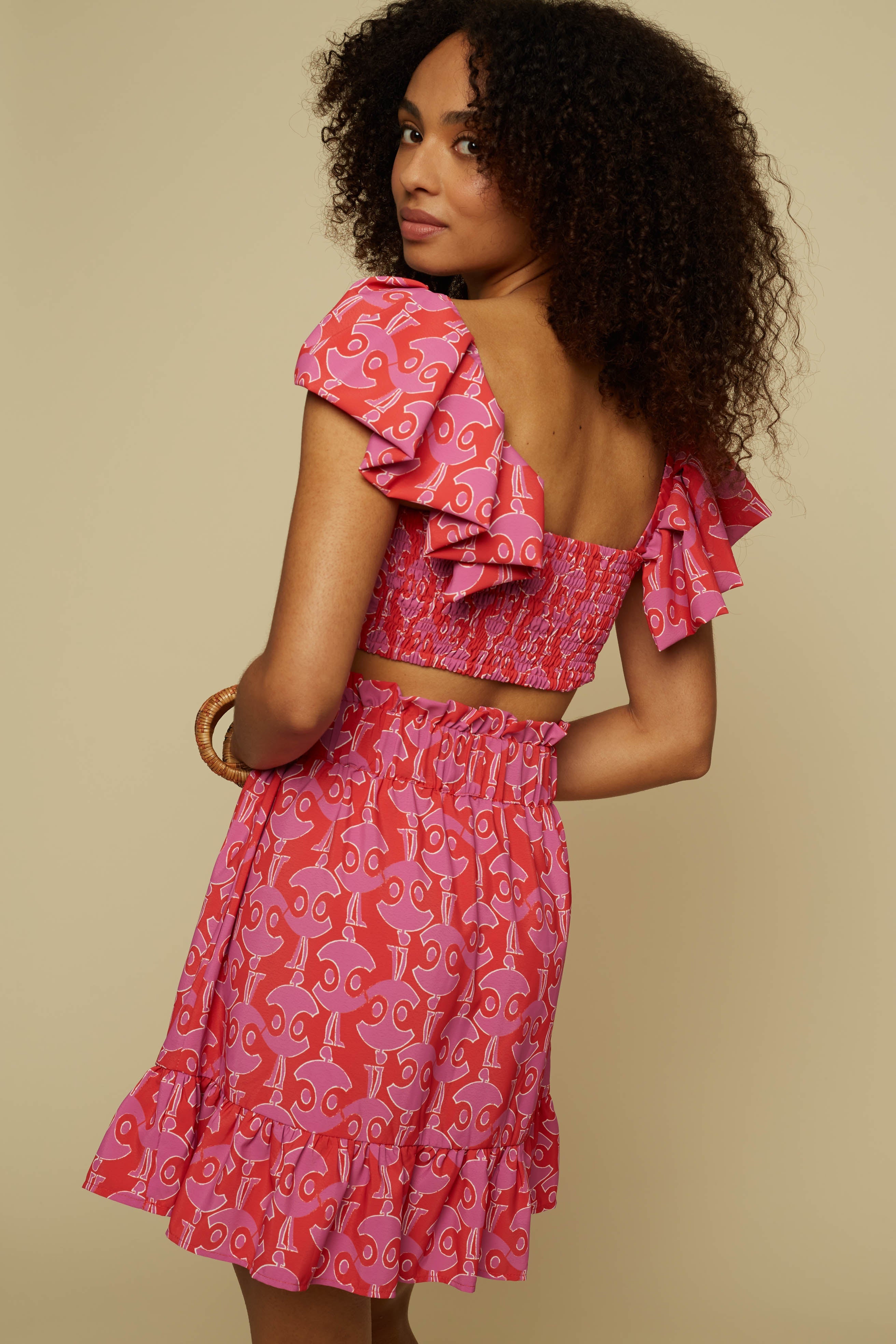 TECTON CROP TOP (PINK GEO PEOPLE PRINT)